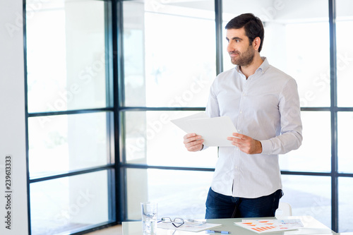 Young caucasian businessman standing in office