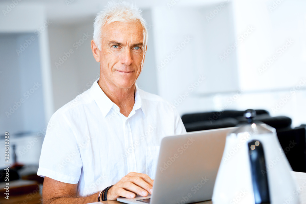 Man working on laptop at home Man working on laptop at home