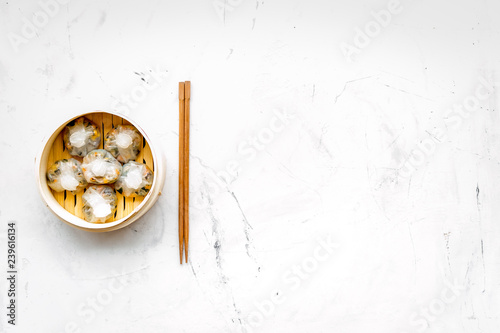 Dinner in Chinese restaurant with dim sum, stick on marble background top view space for text