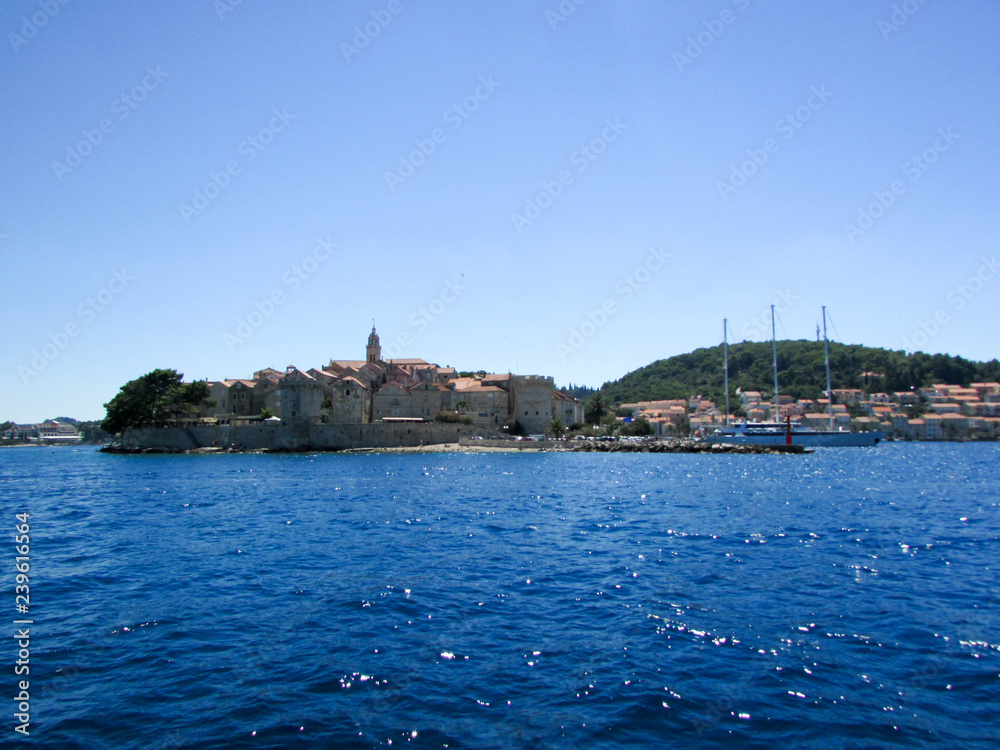 Panorama of Korcula old town, homeland of Marco Polo, from adriatic sea, Croatia