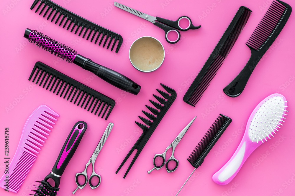 Set of professional hairdresser tools with combs pink background top view Set of professional hairdresser tools with combs pink background top view