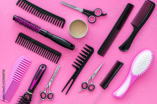 Set of professional hairdresser tools with combs pink background top view
