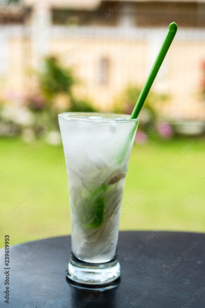 Indonesian Ice coconut drink or es kelapa muda on glass with outdoor location