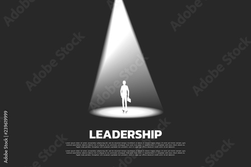 Silhouette of businessman with briefcase in spotlight. business concept of recruitment and highlight person