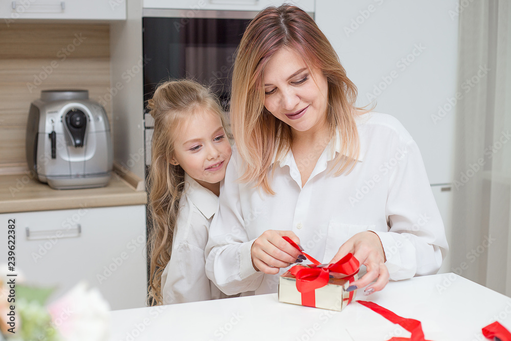 Daughter giving her mother a christmas present Daughter giving her mother a christmas present