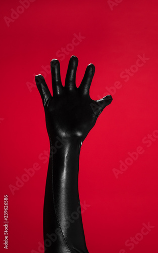 latex fetish hands on red background