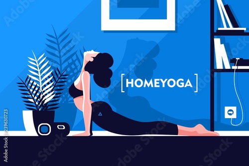 Young beautiful flexible girl doing yoga at home