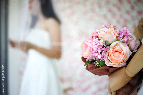 Bride in dress holding wedding bouquet of flowers and greenery,Happy wedding concept.