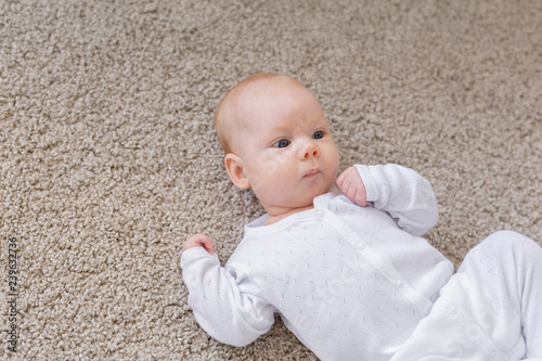 Family, baby and infant concept - Close up portrait of little child on the floor