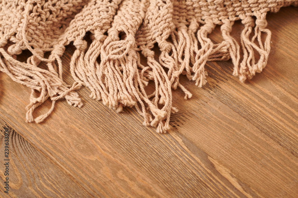 brown knitted blanket on wooden background brown knitted blanket on wooden background