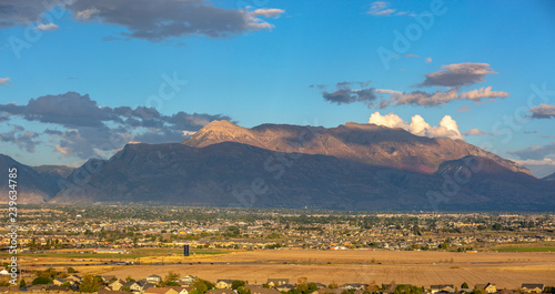 Utah Valley town against mountain and cloudy sky