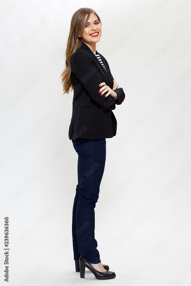 businesswoman in black suit standing with crossed arms.