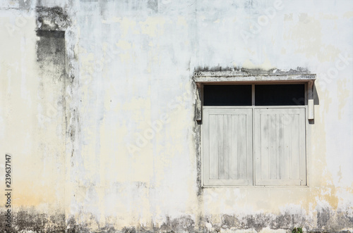 white simple vintage window with awning on grunge cement wall background, copy space © iamtui7