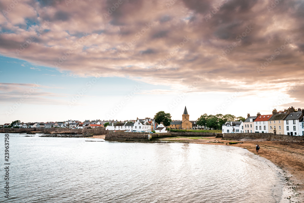 Fototapeta premium Vacation in Scotland with picturesque sunset in the small fishing village Anstruther on the Scottish east coast, not far from St. Andrews, the small fishing boats in the marina are perfect for relaxin