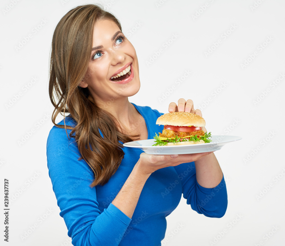 smiling woman holding plate with hamburger. smiling woman holding plate with hamburger.