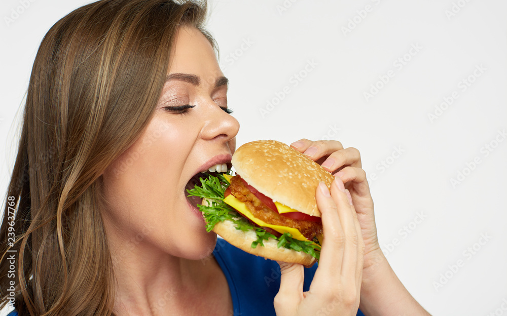 Close up portrait of woman eating cheeseburger