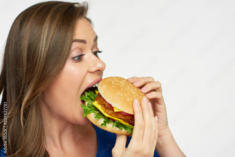 Close up portrait of woman eating cheeseburger