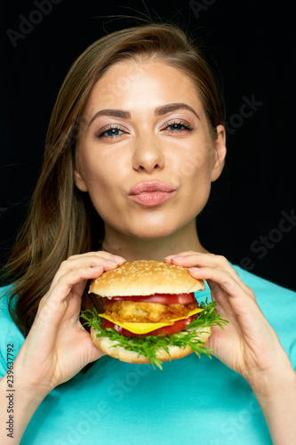 portrait of woman eating hamburger
