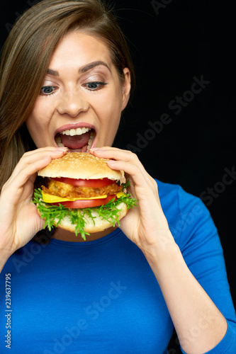 Woman eating cheeseburger  isolated portrait