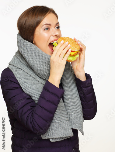 hungry girl bite fast food burger. isolated portrait