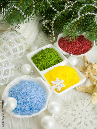 Multicolored sea salt, spa set surrounded by christmas decorations