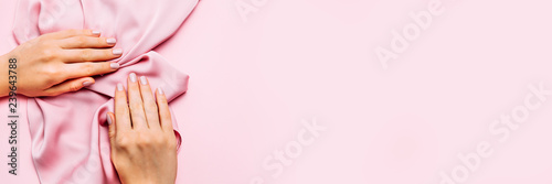 Wallpaper Mural Beautiful woman manicure on creative trendy pink background with silk fabric. Minimalist manicure trend. Top view, flat lay. Copy space for your text. Torontodigital.ca