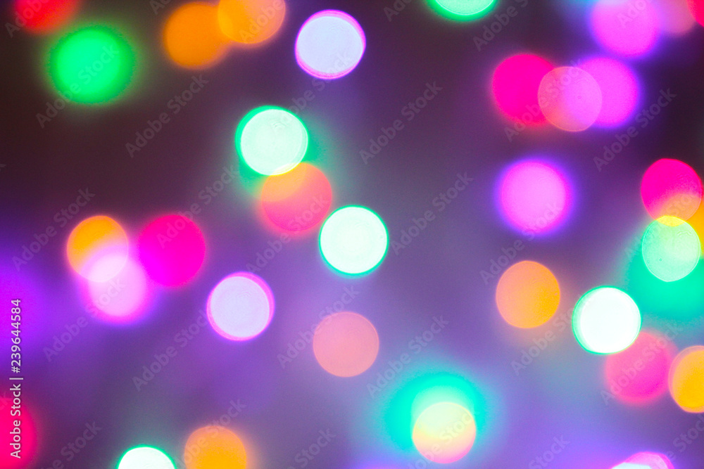 Christmas and new year concept - Defocused abstract multicolored bokeh lights background. Blue, purple, green, orange colors.