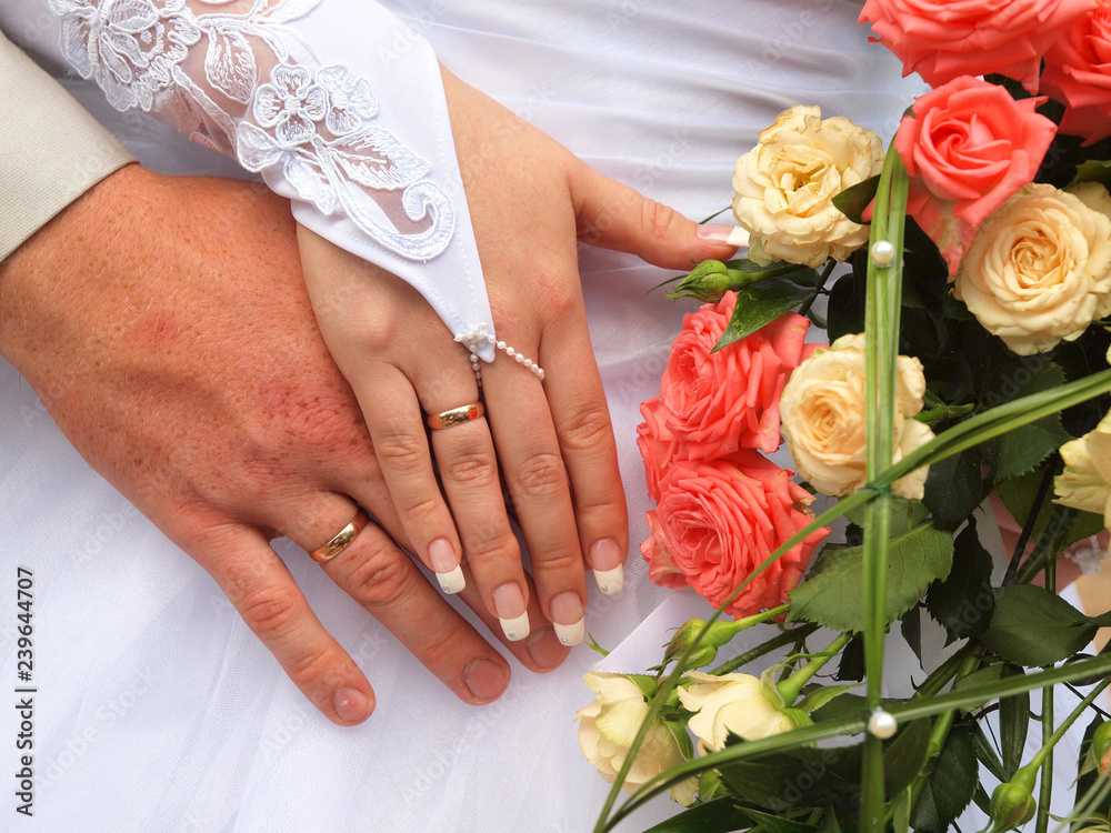 Wedding. Hands newlyweds with wedding rings and bridal bouquet Wedding. Hands newlyweds with wedding rings and bridal bouquet