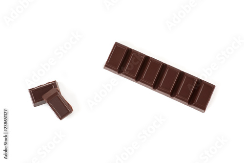 Close-up pieces of chocolate bar with filling isolated on white background. photo