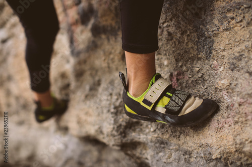 Rock climber, bottom view with his foot on the foreground.