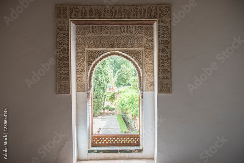 Fototapeta Naklejka Na Ścianę i Meble -  Closeup of a beautiful medieval time architecture seen inside Alhambra Palace. The architecture seems apalling and stunning with details. The design is similarly fascinating.