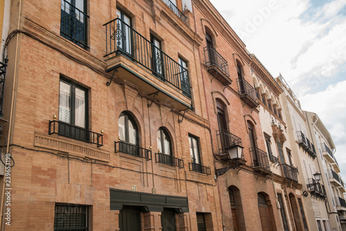 Exterior of a local building in Spain. The building seems to be a mix of old and modern architecture. The Streets seem to be narrow. It seems to be a sunny day. © EugeneF