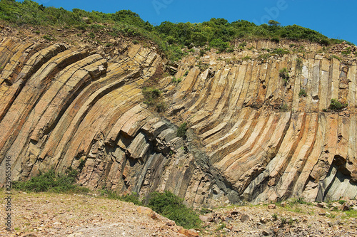 Bent hexagonal columns of volcanic origin at the Hong Kong Global Geopark in Hong Kong, China.