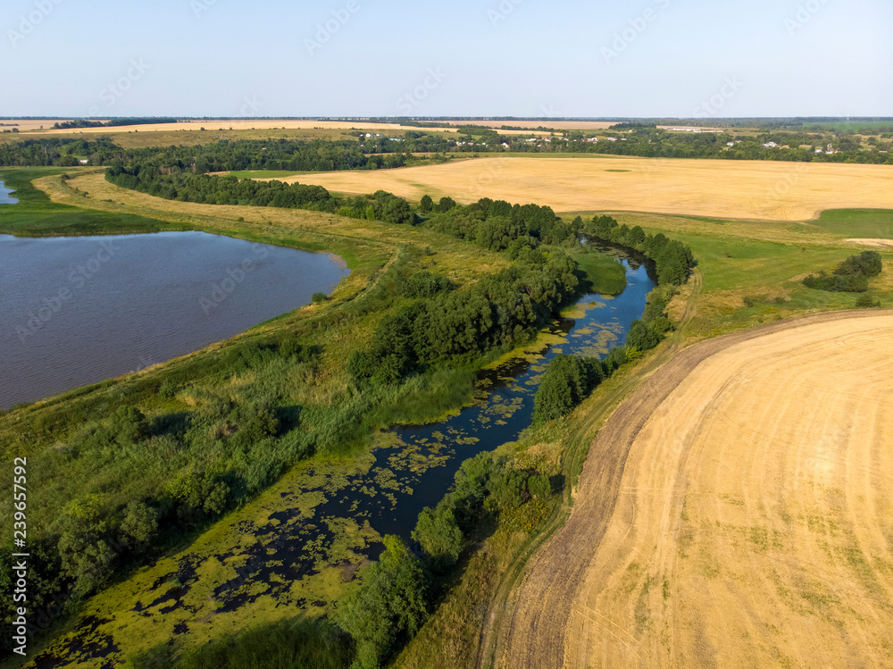 Natural landscape of central Russia with field, river in August