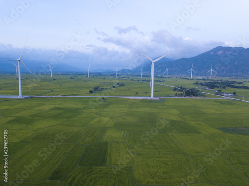 Wind turbine farm or windmill on blue sky. Turbine green energy electricity or wind turbine in a green field - Energy Production with clean and Renewable Energy. Phan Rang, Vietnam