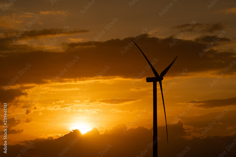 Obraz premium Wind turbine farm or windmill on golden sunset sky in summer day. High-quality stock photo image of wind turbine or windmill for clean energy concept. Energy Production with clean and Renewable Energy
