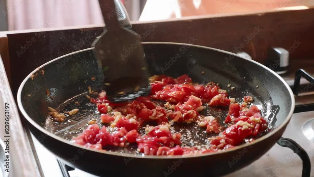 Cooking tomato sauce for spaghetti on frying pan, close-up Cooking tomato sauce for spaghetti on frying pan, close-up
