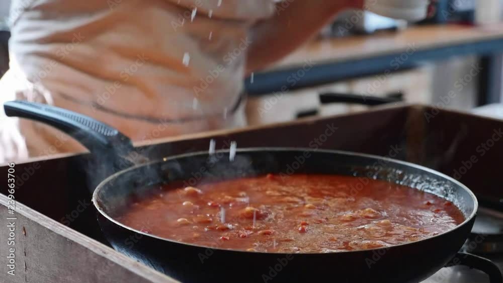 Cooking tomato sauce for spaghetti on frying pan, close-up Cooking tomato sauce for spaghetti on frying pan, close-up