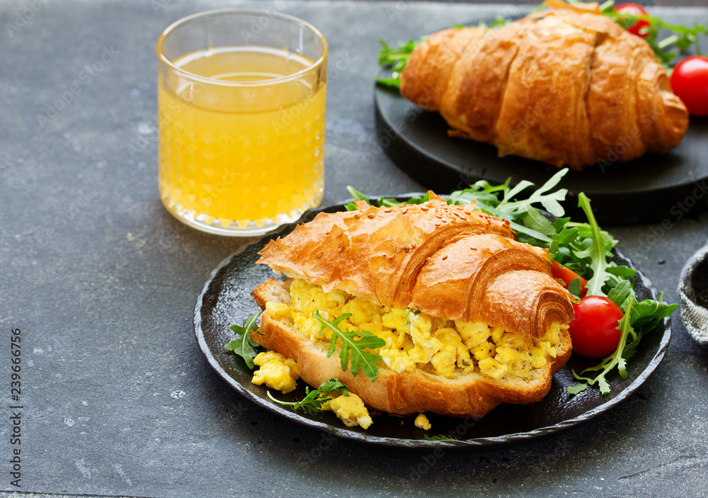 Breakfast of croissant with scrambled eggs and salad. Breakfast of croissant with scrambled eggs and salad.