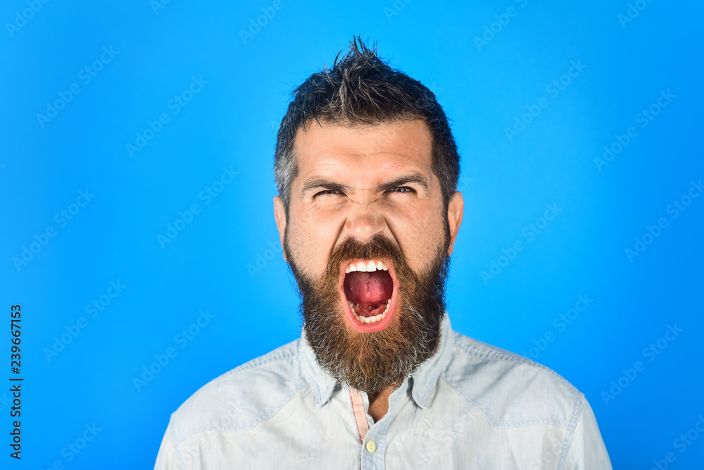 Shout man with long beard and mustache. Hipster in white shirt. Screaming bearded man in casual clothes. Fashion model with stylish hair. Barber fashion and beauty. Fashionable bearded male. Portrait. Shout man with long beard and mustache. Hipster in white shirt. Screaming bearded man in casual clothes. Fashion model with stylish hair. Barber fashion and beauty. Fashionable bearded male. Portrait.