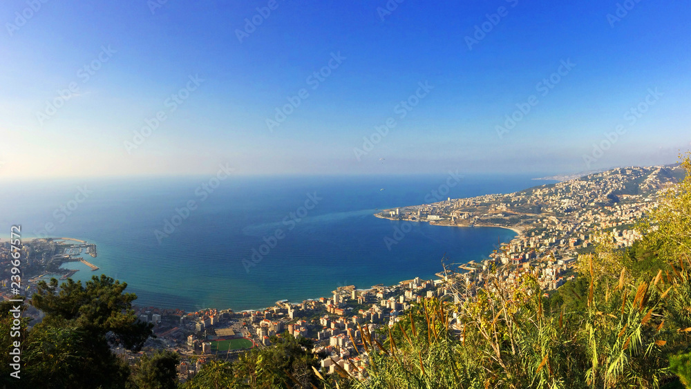 Fototapeta premium View of Jounieh bay with tiny paragliders flying about 
