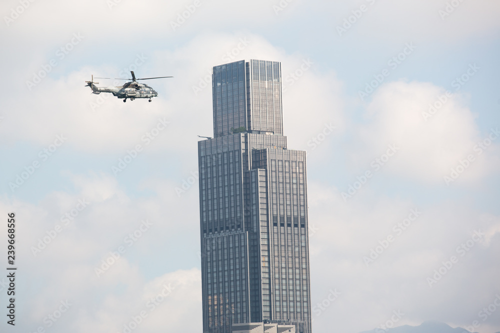 Obraz premium Helicopter and Skyscraper
