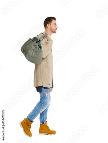 back view of walking  man  with green bag. © ghoststone