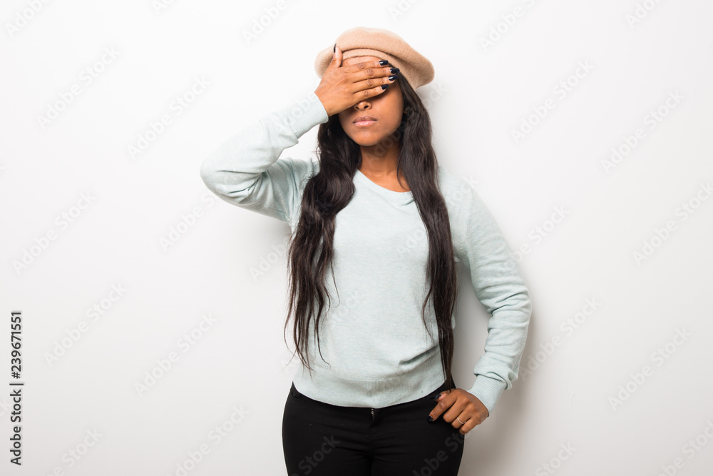 Young afro american woman on white wall covering eyes by hands. Do not want to see something Young afro american woman on white wall covering eyes by hands. Do not want to see something