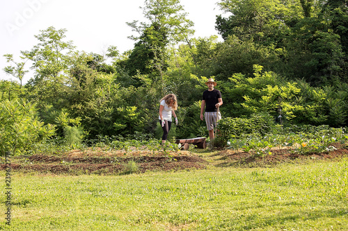 Young man and woman Working in a Home Grown Vegetable Garden © Simon Kovacic