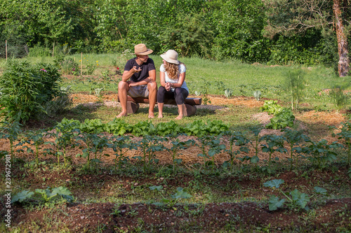 Young man and woman sitting and chatting in a Home Grown Vegetable Garden