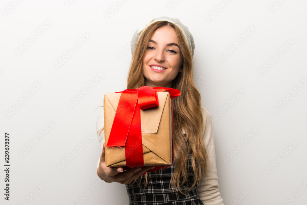 Fashionably woman wearing hat holding a gift in hands Fashionably woman wearing hat holding a gift in hands