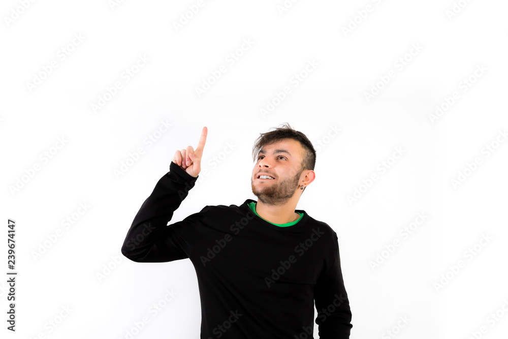 Nice and modern young with beard pointing up isolated on white background Nice and modern young with beard pointing up isolated on white background
