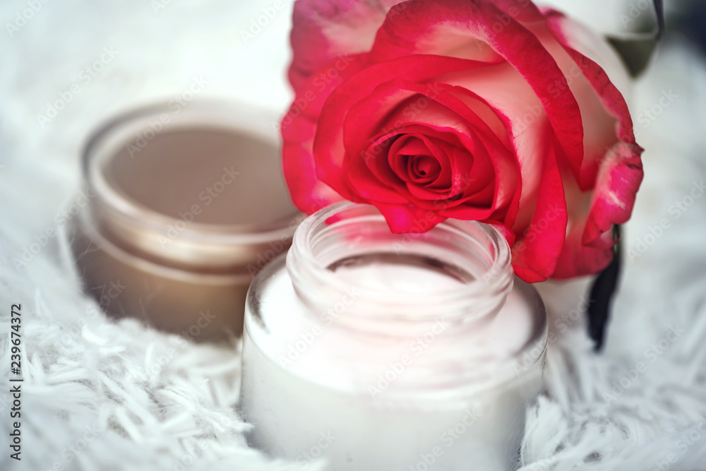 open round jar with cream and rose open round jar with cream and rose