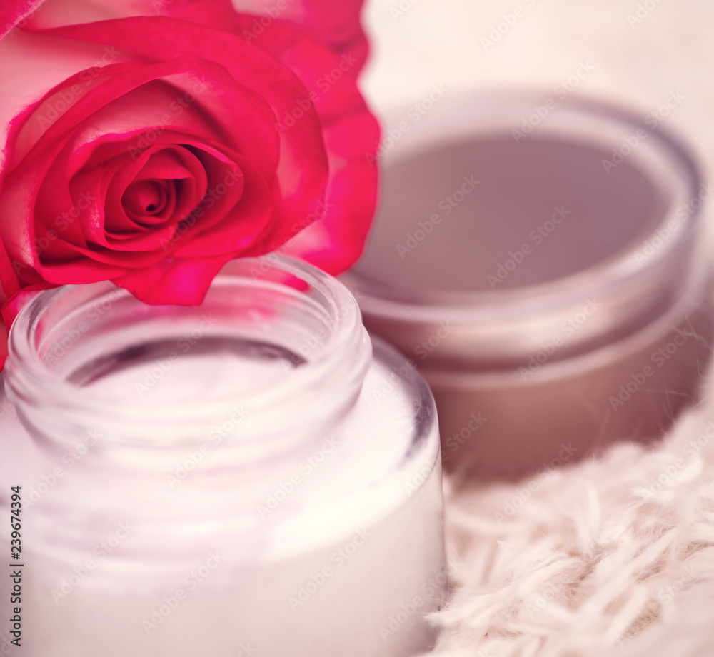 open round jar with cream and rose open round jar with cream and rose